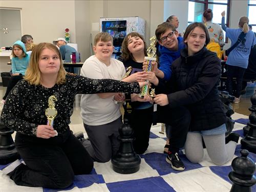 four students holding trophy